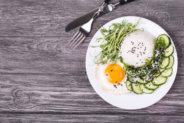 Rice with cucumber, scrambled eggs, microgreen and Japanese wakame seaweed salad.