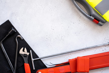Naklejka premium car emergency kit - warning triangle danger sign, first aid kit and reflective vest, metal hook part of the Jack device.