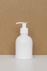 Sanitizer or antiseptic gel to prevent coronavirus disease. Virus protection concept. Pure white bottle on a brown background. Hygiene, the warn of germs and bacteria.