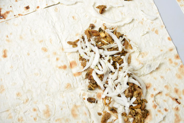 Cabbage sprinkled on meat and laid on pita bread.