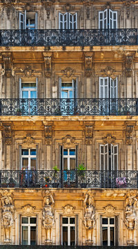 Facade of antique buiding with wooden windows.