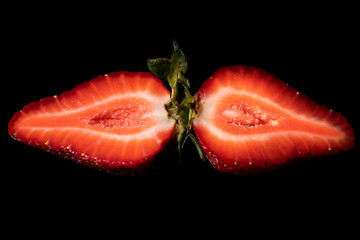 Strawberries on a black background. Strawberries are delicious fruits that are common in Romania, from start of may until the end of the summer