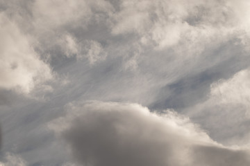blue sky with many thick, dark clouds