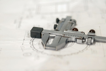 The caliper lies on the technical drawing, production and manufacture of the gear shaft and wheel.