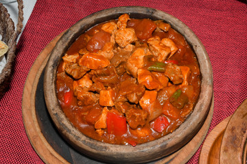 Home cooked lamb and beef or pork stew, served in a traditional restaurant, in wooden bowl