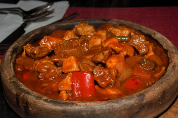 Home cooked lamb and beef or pork stew, served in a traditional restaurant, in wooden bowl