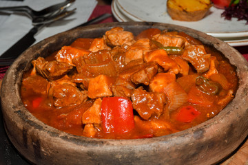 Home cooked lamb and beef or pork stew, served in a traditional restaurant, in wooden bowl