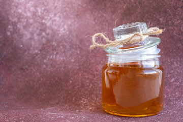 Composition with fresh honey on maroon background