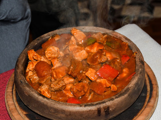 Home cooked lamb and beef or pork stew, served in a traditional restaurant, in wooden bowl