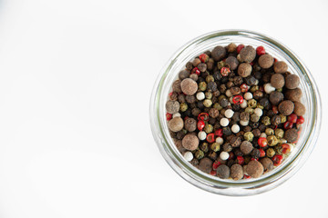 jar with multi-colored dry pepper on an isolated white background