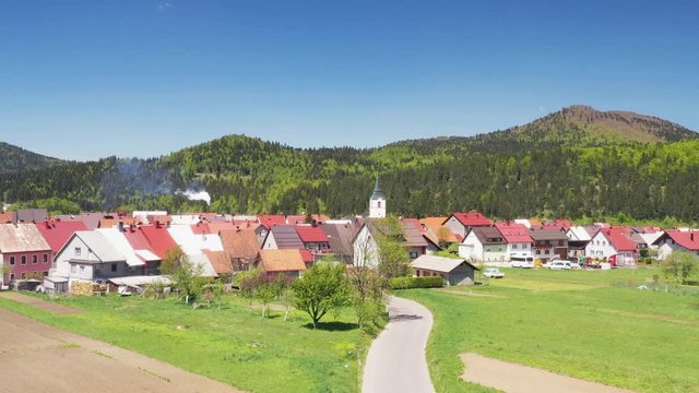 Croatia, town of Delnice, Gorski kotar, panoramic view of town center from drone in spring, mountain landscape in background