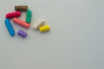 
colored chalks on white background