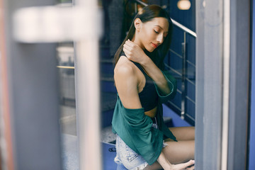 Beautiful girl in a cafe. Stylish girl in a green blouse. Lady near the window