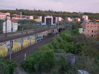 Fototapeta na wymiar czech railway tracks at sunset and in the background is prague architecture in spring 2020
