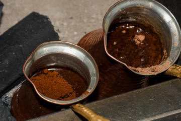 Coffee in metal Turkish traditional cup, being served in a traditional cafe bar in Istanbul, Turkey