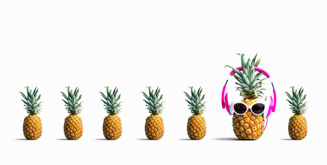 One out unique pineapple wearing headphones on a solid color background
