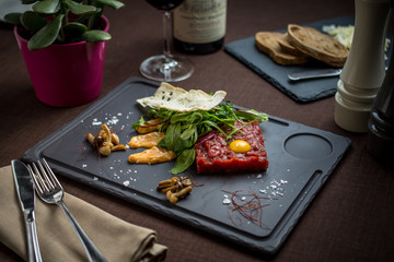 Fresh beef meat tartar with green leaves