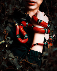 young russian girl with a snake in her hands
