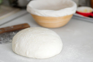 Fototapeta na wymiar Homemade freshly prepared dough for fresh healthy bakery and pastry on a white kitchen table.