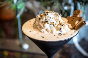 White latte coffee drink with a cookie in a bar