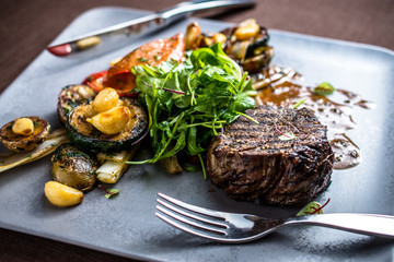 Grilled beef meat with grilled vegetables, gravy