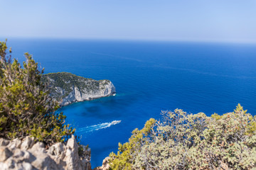 yacht soars the deep blue sea near the beautiful Navagio beach on the island of Zakynthos in Greece