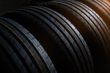 New tires set on the dark background with warm light in the corner.
