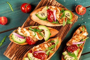 The concept of oriental cuisine. National Cyprus Sandwich grilled Halloumi cheese and slices of avocado on a light background. Healthy vegetarian food. Top view, overhead