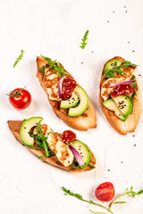 Healthy toasts with grilled Halloumi cheese and slices of avocado on a light background. Healthy vegetarian food. Top view, overhead, cuisine of Cyprus