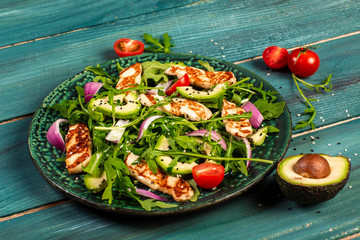 Traditional Greek cuisine of Cyprus. Salad with grilled Halloumi with tomatoes, avocado, and arugula. Vegan food. Diet menu. Flat lay banner menu