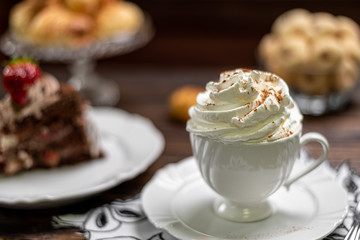 Coffee cup and chocolate cake on wooden table background