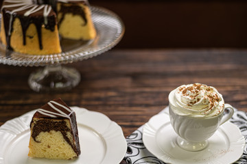Coffee cup and chocolate cake on wooden table background