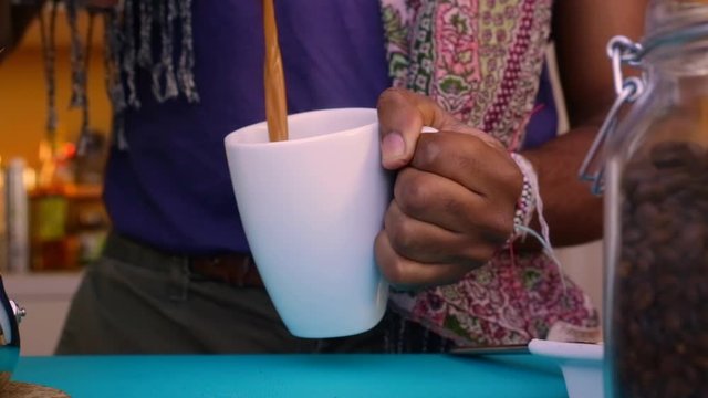 Person making bulletproof coffee with butter and MCT oil - 25 sec