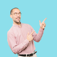 Cool young man pointing with his fingers