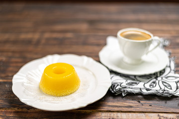 A brazilian dessert made with eggs and coconut. Quindim on wooden background