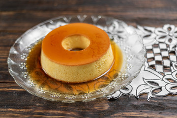 Milk Pudding or Pudim de leite. Brazilian dessert homemade caramel custard pudding. Traditional brazilian flan on wooden background
