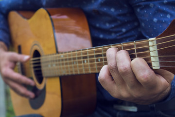 Fototapeta premium Young guy plays guitar