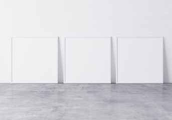 Three white square frames Standing on concrete gray floor with white background, minimal frame mock up interior 