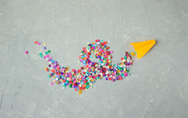 a salute of paper colored confetti on a gray surface. Space for text. Minimalism of the great victory day in world war 2