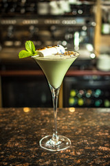 White cocktail with burned marshmallows in a bar