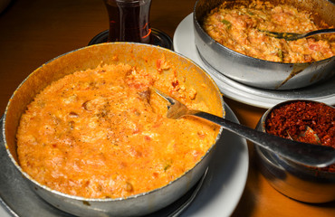 Traditional turkish food breakfast dish menemen made by eggs and tomatoes and different fillings