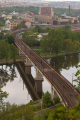 
railway bridge in Prague over the Vltava river in the spring of 2020 in the Czech Republic. reflections can be seen on the surface