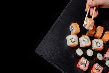 Set of sushi roll on black slate background food fish philadelphia japanese salmon delicious sushi rice cucumber meal traditional wasabi fresh healthy gourmet raw cuisine