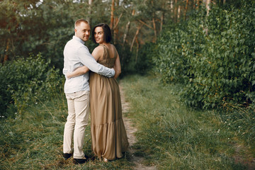 Pragnant woman. Family in a field. Man in a white shirt