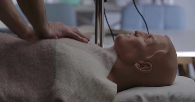 Unrecognizable man practicing first aid on mannequin. Male hands pressing chest doing external heart massage. Health care. help, medical concept. Cinema 4k ProRes HQ.
