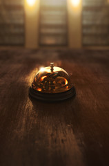 3D illustration of a concierge hotel bell on a wooden background - obrazy, fototapety, plakaty