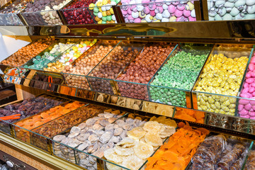 Various types or many colorful assortment of Turkish delights rolls for sale in a shop in Istanbul, or on the street during street food festival. Lokum, a specific Turkey dessert sweets on the market
