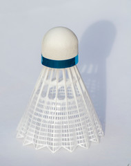 plastic  Badminton shuttlecock. Macro horizontal banner of a plastic  shuttlecock with shadow on the white background. Design of a shuttlecock. Badminton accessories. Sports equipment. place for text