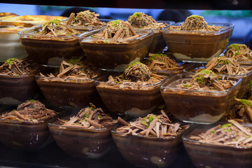 Chocolate mousse pudding in portion glasses on stack one over another