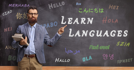 Language teacher in front of a blackboard with text learn languages